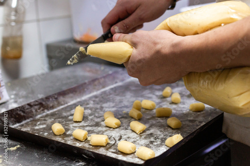 chef hands preparing homemade gnocchi in restaurant