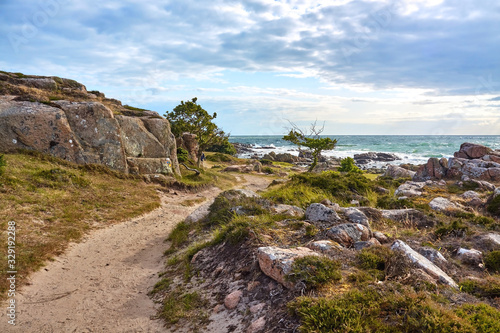 A footpath along Baltic Sea coast on the northern part of Hammeren peninsula, Bornholm island, Denmark..