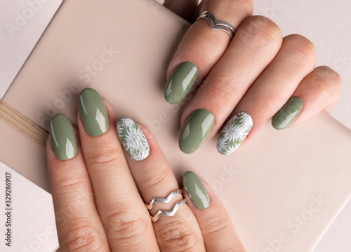 Beautiful womans hands with spring summer floral nail design