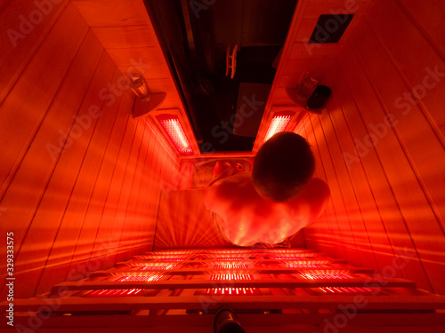 Man relaxing in a luxury infrared sauna