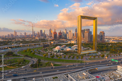 Aerial view of Dubai Frame, Downtown skyline, United Arab Emirates or UAE. Financial district and business area in smart urban city. Skyscraper and high-rise buildings at sunset.