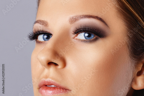 Woman face with eyes with long eyelashes and smokey eyes make-up. Eyelash makeup, cosmetics, beauty