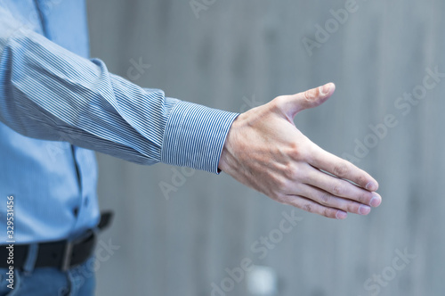 Businessman holds out his hand for a handshake