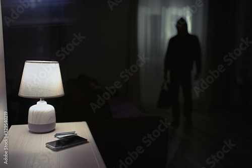 Burglar inside of a house with flashlight 