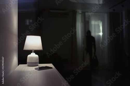 Burglar inside of a house with flashlight 