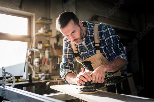 Carpenter working on woodworking in carpentry workshop