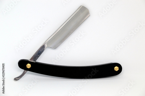 Black straight razor isolated on white background