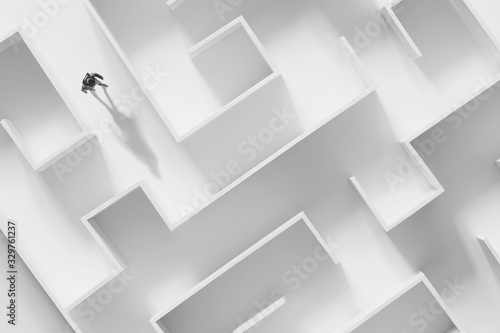 man walking in a complex white maze, surreal concept