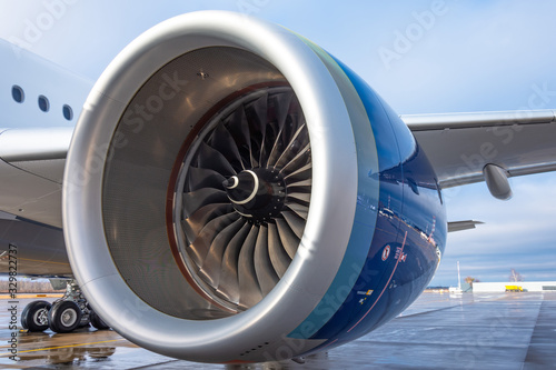 Aircraft engine near, passenger aircraft parked at the airport.