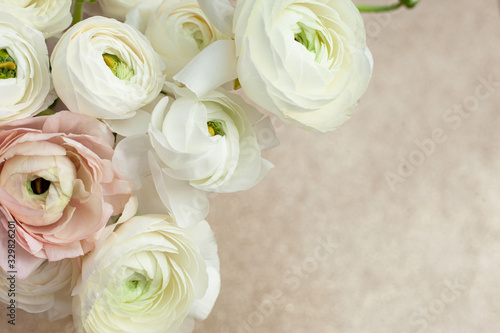 Elegance ranunculus bouquet on the sparkling background. Beautiful and tender flowers composition. Perfectly for Birthday, Women's and Valentine's Day, Anniversary. Copyspace. Top view.