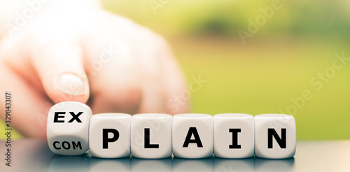 Explaining instead of complaining. Hand turns dice and changes the word "complain" to "explain".