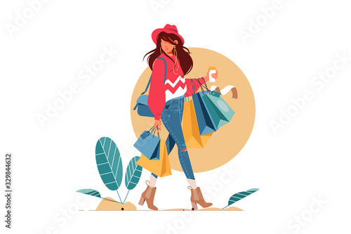 Young attractive fashionable woman holding packages with clothes after shopping.