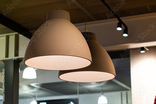 Indoor bar light fixtures round grey hanging from the ceiling low angle view