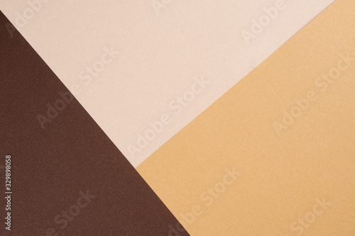 Background from recycled textured paper forming triangular shades of dark brown