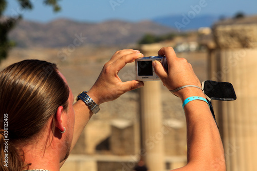 Lindos, Rhodes / Greece - June 23, 2014: Tourist take a picture in Lindos acropolis, Rhodes, Dodecanese Islands, Greece.