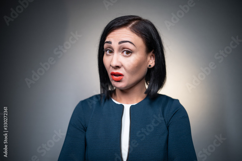 studio shot of brunette female has aggression and disgust