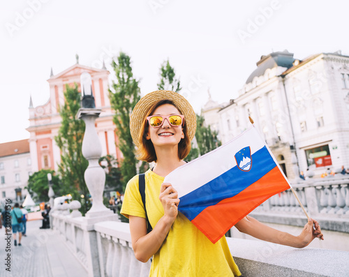 Woman tourist with slovenian flag in Ljubljana, Slovenia, Europe.