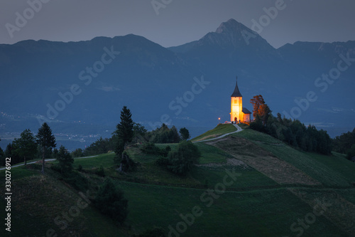 The church of Saints Primus and Felician at Jamnik, Slovenia, with the Kamnik Alps in the background