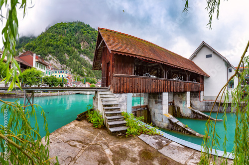Panoramic view of weir on Aare river of Old City of Unterseen, Interlaken, important tourist center in the Bernese Highlands, Switzerland