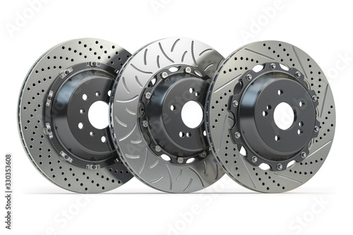 Different types of brake disks. Drilled and slotted brake disks in a row.