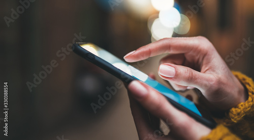 point finger on screen phone closeup, person texting text message, hipster touch blue screen on smartphone light night city, girls using in hands mobile phone close up, online wi-fi