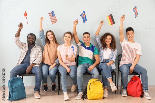 Young students of language school near color wall