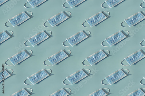 Pattern of Medical mask on blue background, flat lay top view.