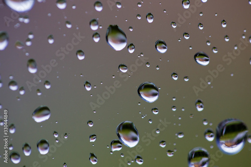 Gouttes d'eau sur une vitre avec reflets