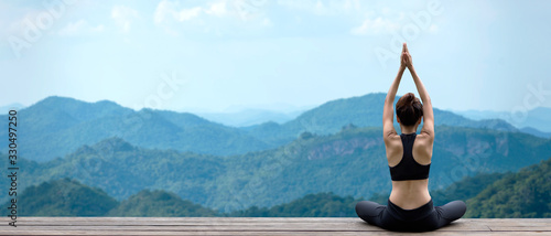 Lifestyle woman yoga exercise and pose for healthy life. Young girl or people pose balance body vital zen and meditation for workout nature mountain background in morning day. Copy space for banner. 