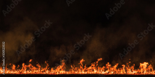 burning dry field in night