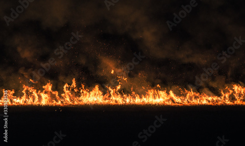 burning dry field at night