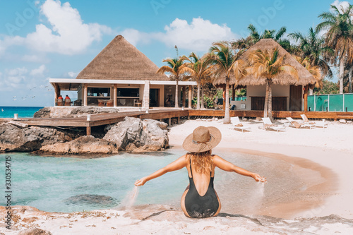 woman on the mexican beach on Cozumal is watching the caribbean sea