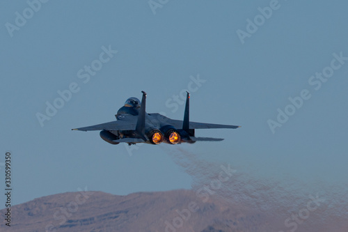 Very close tail view of a F15 Eagle with afterburner on