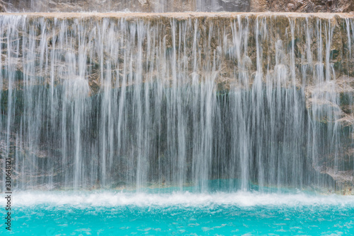 landscape of beautiful Artificial waterfall in garden at the public park