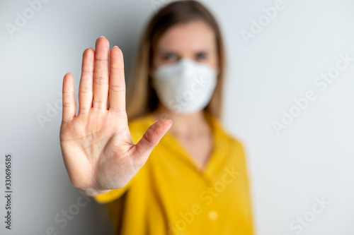 Virus mask woman wearing face protection in prevention for coronavirus showing gesture Stop Infection