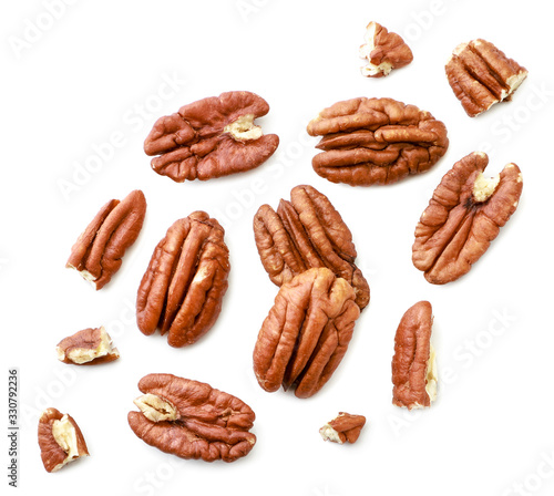 Peeled pecans with broken halves and pieces on a white background. The view from top.
