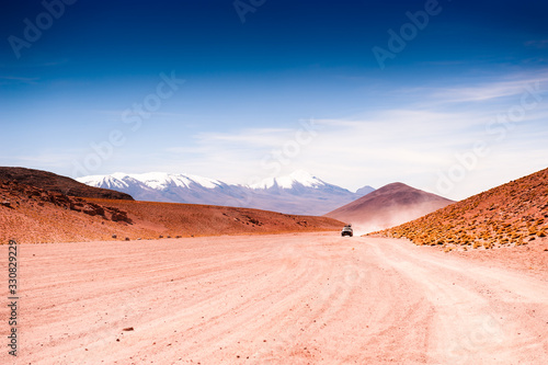 Off-road cars driving on the road in the desert on plateau Altiplano, Bolivia. South America landscapes