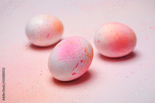 Hand painted Easter eggs on a background of multicolored pastel 