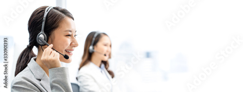 Banner of smiling telemarketing Asian woman working in call center office