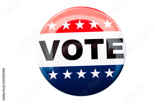 Democracy, presidential election and voting poll concept with red, white and blue vote glossy button pin with stars and stripes isolated on white background with clipping path cutout