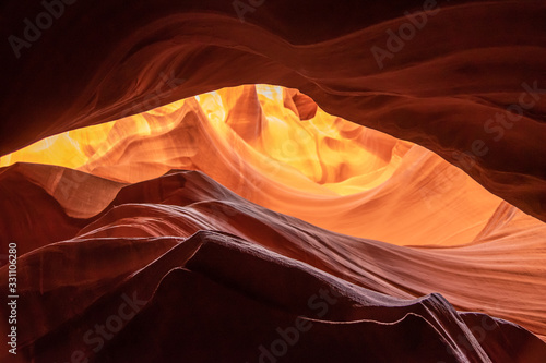 Unique & stunning Antelope Canyon located near Page, Arizona. Looking up into the famous tourist area during summer time with sun shining down through canyon walls 