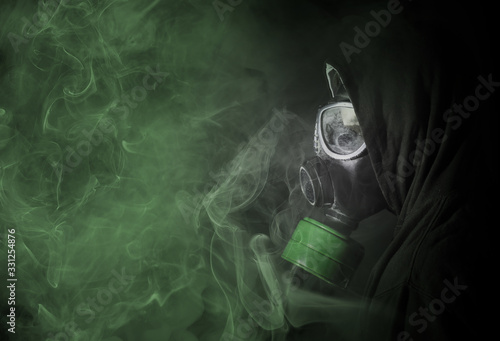 Man in a gas mask in the toxic smoke