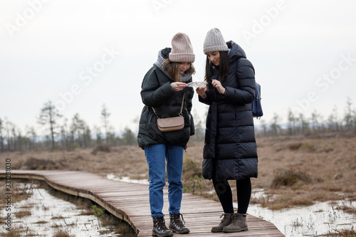 Two friends walk in the woods. Girls relax in nature