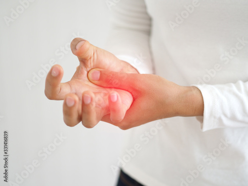 rheumatoid arthritis and repetitive motion injuries,including carpal tunnel syndrome in woman and she touching on her hand with red and symptoms of pain and swelling use for health care concept.