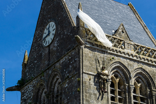 American John Steele paratrooper memorial hanging at the church rooftop ot Sainte-Mère l'Eglise, Normandy, France.