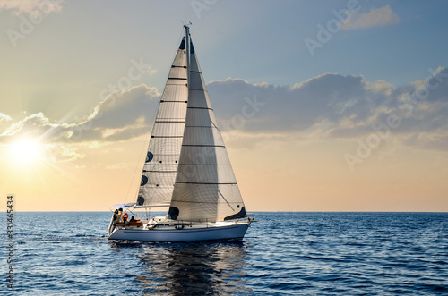 close-up sailboat sailing under a beautiful sunset