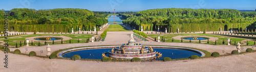 Panoramic view of the Versailles Park - the Latona Basin with the Grand Canal in the background under the summer sun, Versailles, France
