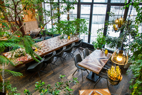 Interior of modern loft style restaurant. Interior porch with fresh flowers