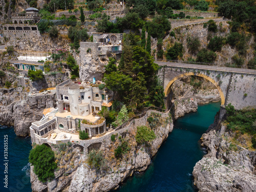 Aerial view of Fiordo di furore beach. Incredible beauty panorama of a paradise. The rocky seashore of southern Italy. Sunny summer day. Stone bridge and clear water. Amalfi coast.