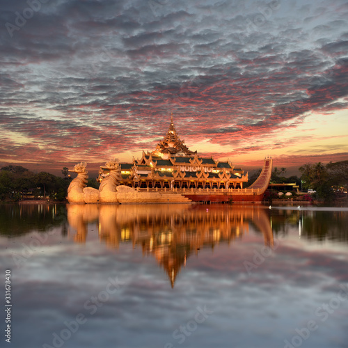 The Karaweik is a Burmese Royal Barge reflecting in Kandawgyi Lake while sunset, Yangon, Myanmar
